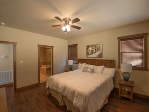 Master suite #1 featuring a king size bed and 40 inch TV with luxury bedding. Equipped with custom made Amish Furniture