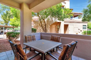 Outdoor covered patio with table and 4 cushioned chairs
