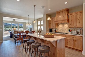 Kitchen Island View Into Dining Room - Enjoy preparing meals in the well equipped gourmet kitchen.