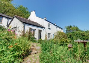 This delightful semi-detached character cottage is set within a canopy of ancient trees with an abundance of ferns and wild flowers