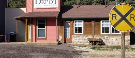 the front access door is to the left, under the porch.
