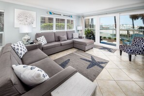 Spacious Living Room features Wall to Wall Sliding Glass Doors