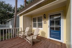 A front porch with Adirondack chairs. A perfect spot for morning coffee on a sunny morning.