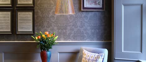 Sitting Room:  light floods the reading corner, kept warm by a vintage radiator.