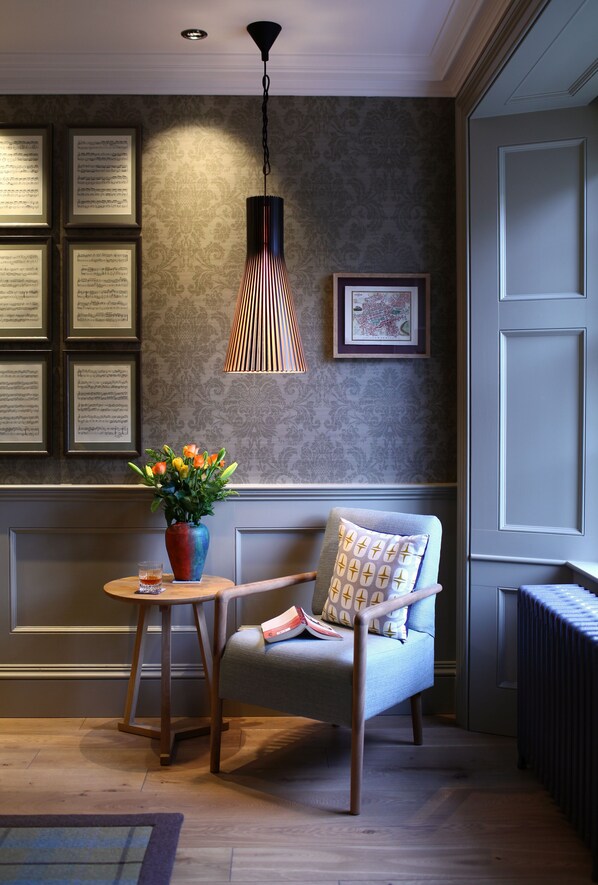 Sitting Room:  light floods the reading corner, kept warm by a vintage radiator.