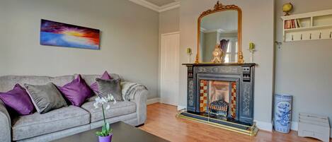 Sitting Room -  original Victorian feature fireplace with ambient brass electric fire, two comfortable sofas, flat screen TV with Freeview & DVD/CD player, WiFi