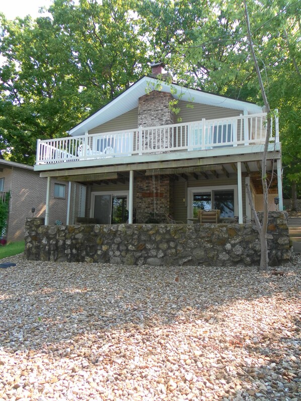 View of house from lake. Gradual slope to lake.