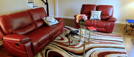 Living Room with  trendy reclining sofa and love seat, glass coffee table