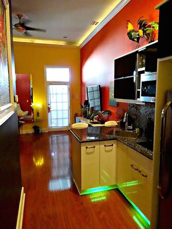 Galley style kitchen, full frig, ice maker, microwave, cooktop, granite counters