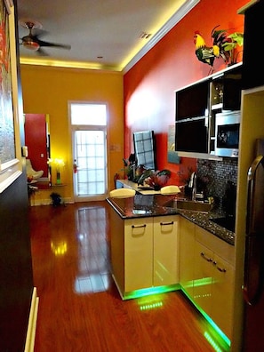 Galley style kitchen with granite counters, new stainless steel appliances, for fridge and icemaker, microwave, two burner cooktop.