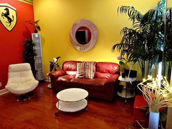 Living room with sleeper sofa, sleeps too, laminate floors, recessed lighting, 50 inch flatscreen TV. Sitting chair