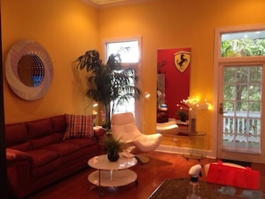 LIVING ROOM, SLEEPER SOFA, SITTING CHAIR LAMINATE FLOORS, BEAUTIFUL ARTWORK