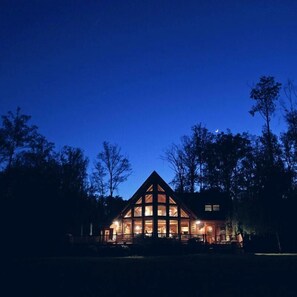 View of Lakeside of the house as seen from the beach during dusk before dark.