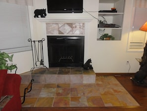 .Slate floor around fireplace with electric insert for ease of use