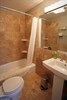 The bathroom w/ heated travertine tile floors