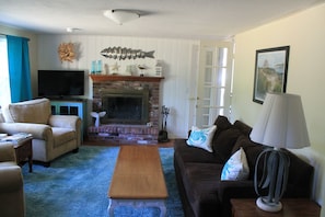 Living room with fireplace and flat screen tv.