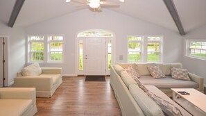 Bright, beachy Great Room, with 55" Smart TV, soaring ceilings & exposed beams.