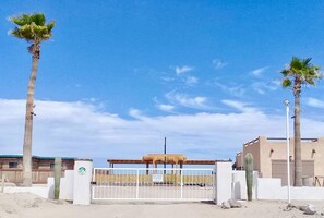 Private community with gated entrance. The house is the tan house to the right. 