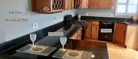 Large complete kitchen is stunning with black granite