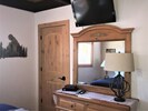 The king-bed bedroom comes with 6-drawer dresser/mirror and HDTV with Roku.