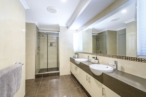 Ensuite bathroom with two shower heads and two vanities.