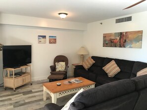 View of living room and new sectional couch with two reclining seats at each end