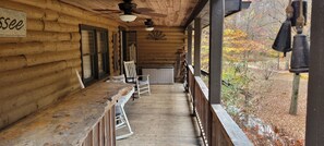 Front Porch view facing front door, lifejacket chest, & fishing poles.