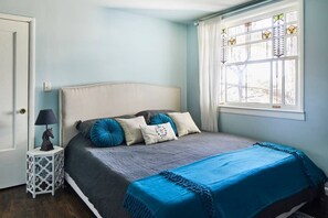 The soothing master bedroom showcases an antique stained glass window. You'll feel well rested after a night in the king size memory foam bed. 