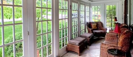 Enjoy your morning coffee or a glass of wine on the glassed-in front porch