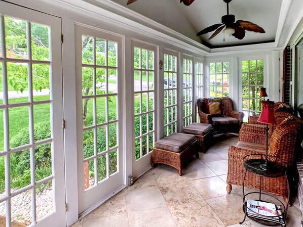 Enjoy your morning coffee or a glass of wine on the glassed-in front porch