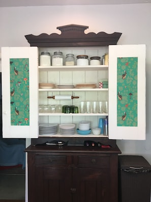 1800's Setback Tall Cabinet houses your dishware, glasses and basic staples