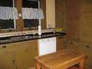 Fully equipped kitchen. Vintage cabinets complimented by granite and tile.