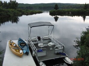 private dock with pontoon boat and kayaks