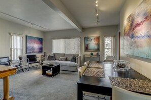 Living room includes a dining table that seats 6 and is expandable