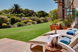 Relaxing next to Jacuzzi overlooking manicured garden - Communal Area