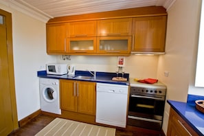 Part view of kitchen of apartment 2 with w/machine d/washer and F/F out of view.