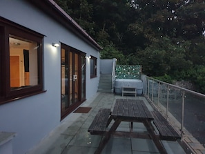 Night time photo with lighting and hottub.