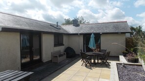 Rear sunny patio with decking and BBQ