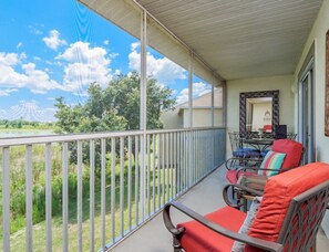 Large Balcony overlooking the lake with dining area and comfy seats for 4 people