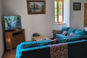 Large seating area with couch , sofa bed & TV ( French & UK channels )