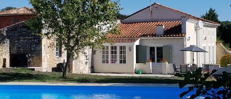 View of the house and terrace from across the heated pool