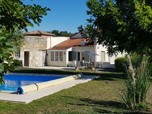 The house and terrace across the pool.  Plenty of welcome shade if needed. 