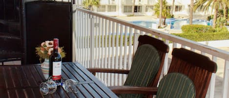 Terrace outside living room overlooking hotel pool complex