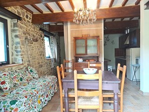 the extendable table , the bed 
/sofa, and the counter in the  dinner room