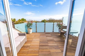 Spacious sunny balcony with great views of the sea and countryside.