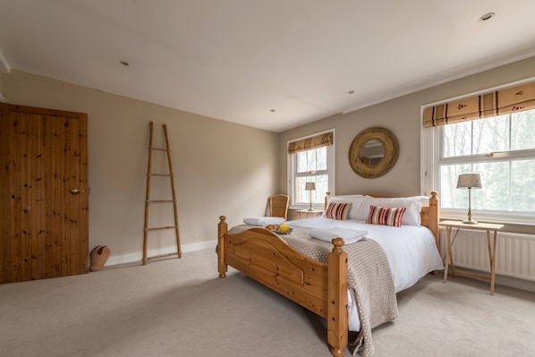 Large master en suite bedroom with rural views, luxury linen and towels