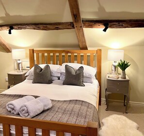 Double bedroom 2 with King bed, TV, leading to twin room, separated by door. 