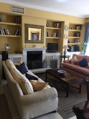 The elegant drawing room with open log-fire for cold winter evenings