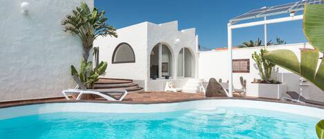 Pool and patio with pergola of solar panels