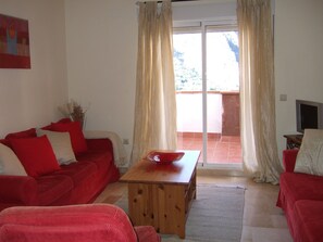 Large living area with panoramic doors to terrace with lake and  mountainviews